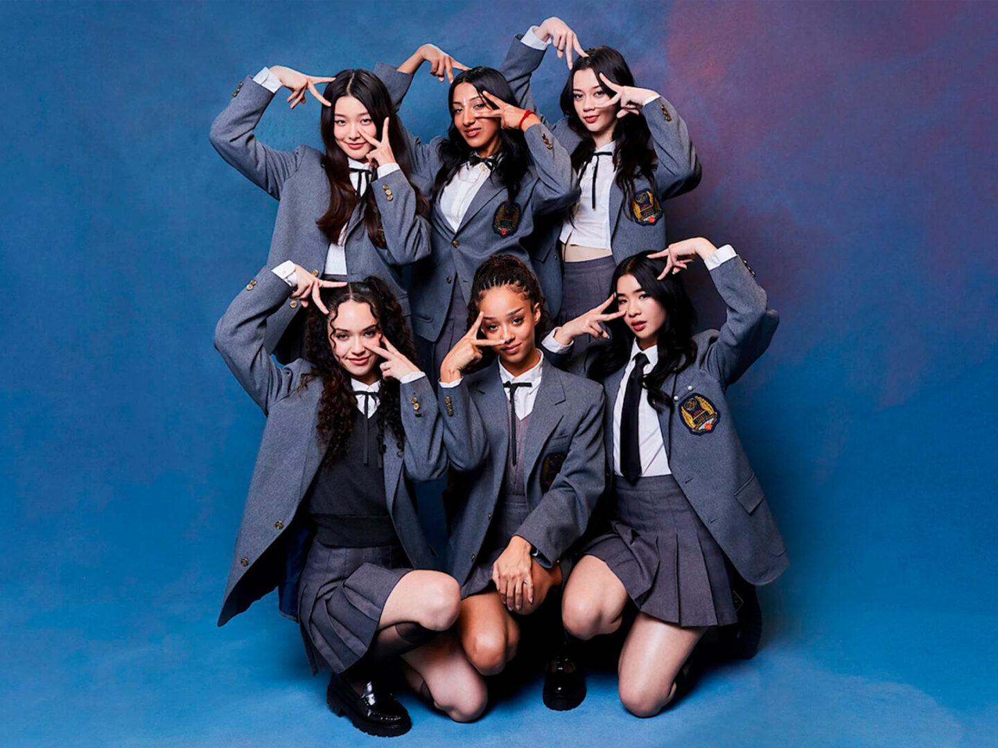 Katseye group photo in school outfits.